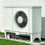Outdoor heat pump unit beside a house