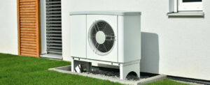Outdoor heat pump unit beside a house