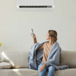 Woman relaxing in a living room with a wall-mounted ductless unit