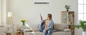 Woman relaxing in a living room with a wall-mounted ductless unit